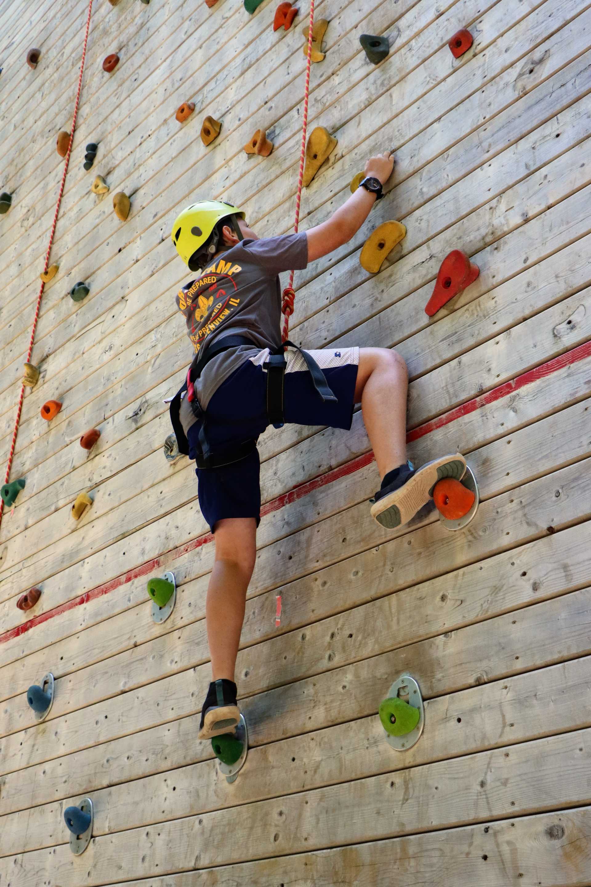 A scout on the climbing wall