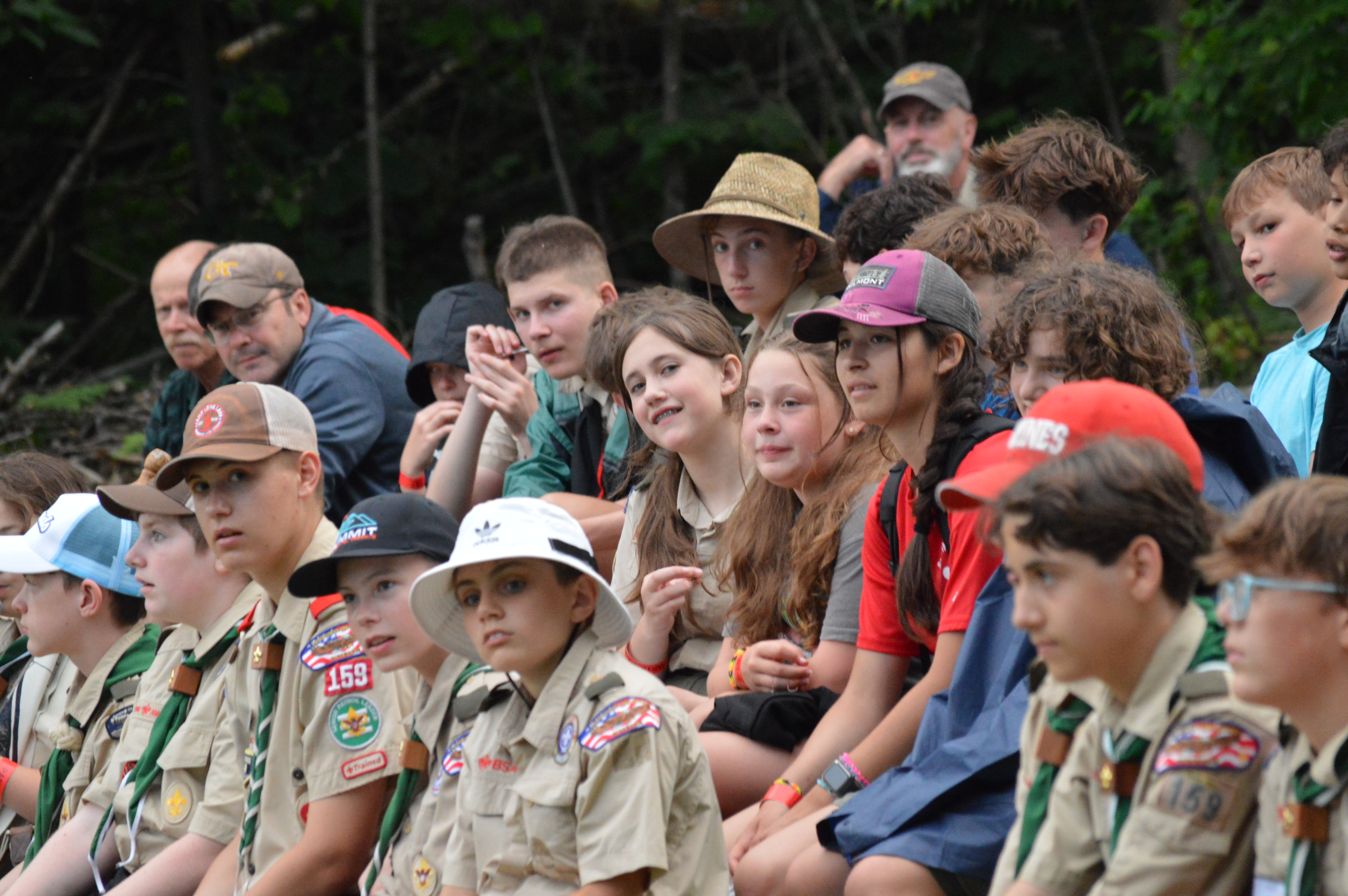 Scouts seated and watching the campfire ceremony.