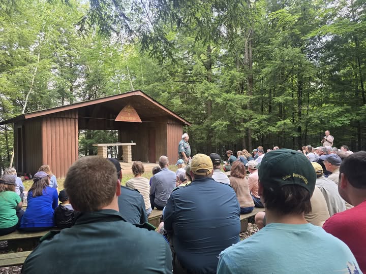 Scouts gather around the remembrance area, a small wooden structure with a ceremonial purpose.