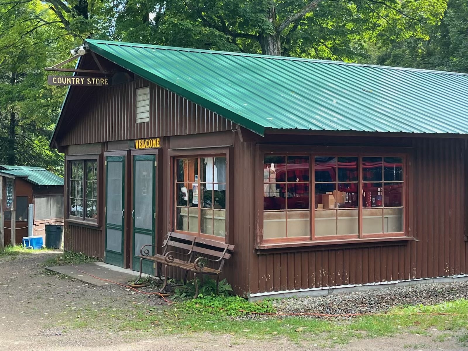 Viewed from outside, the country store is a neat little log-cabin styled building with large windows hosting a number of signs and postings.