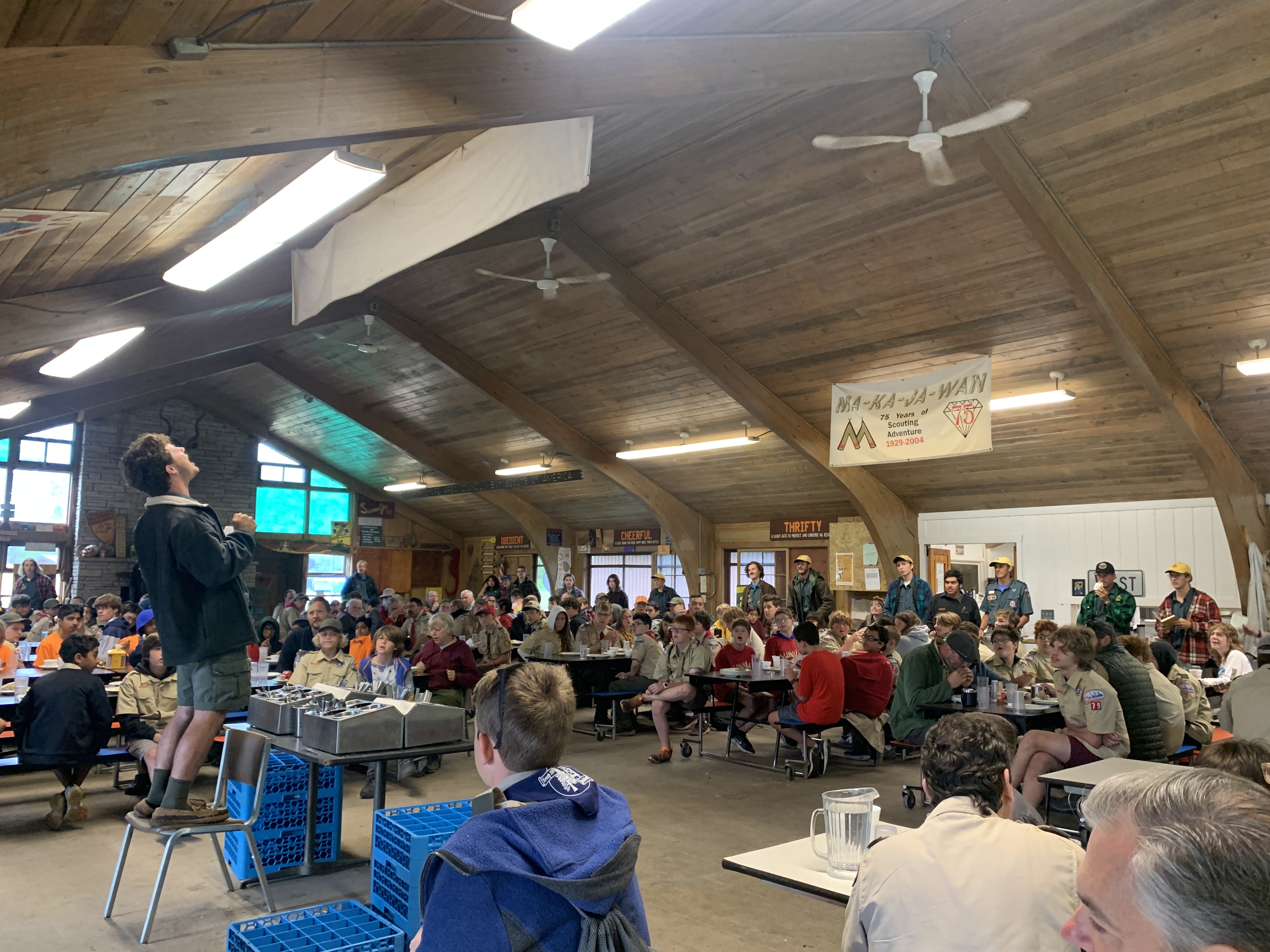 Scouts gather in the dining hall to share a meal.