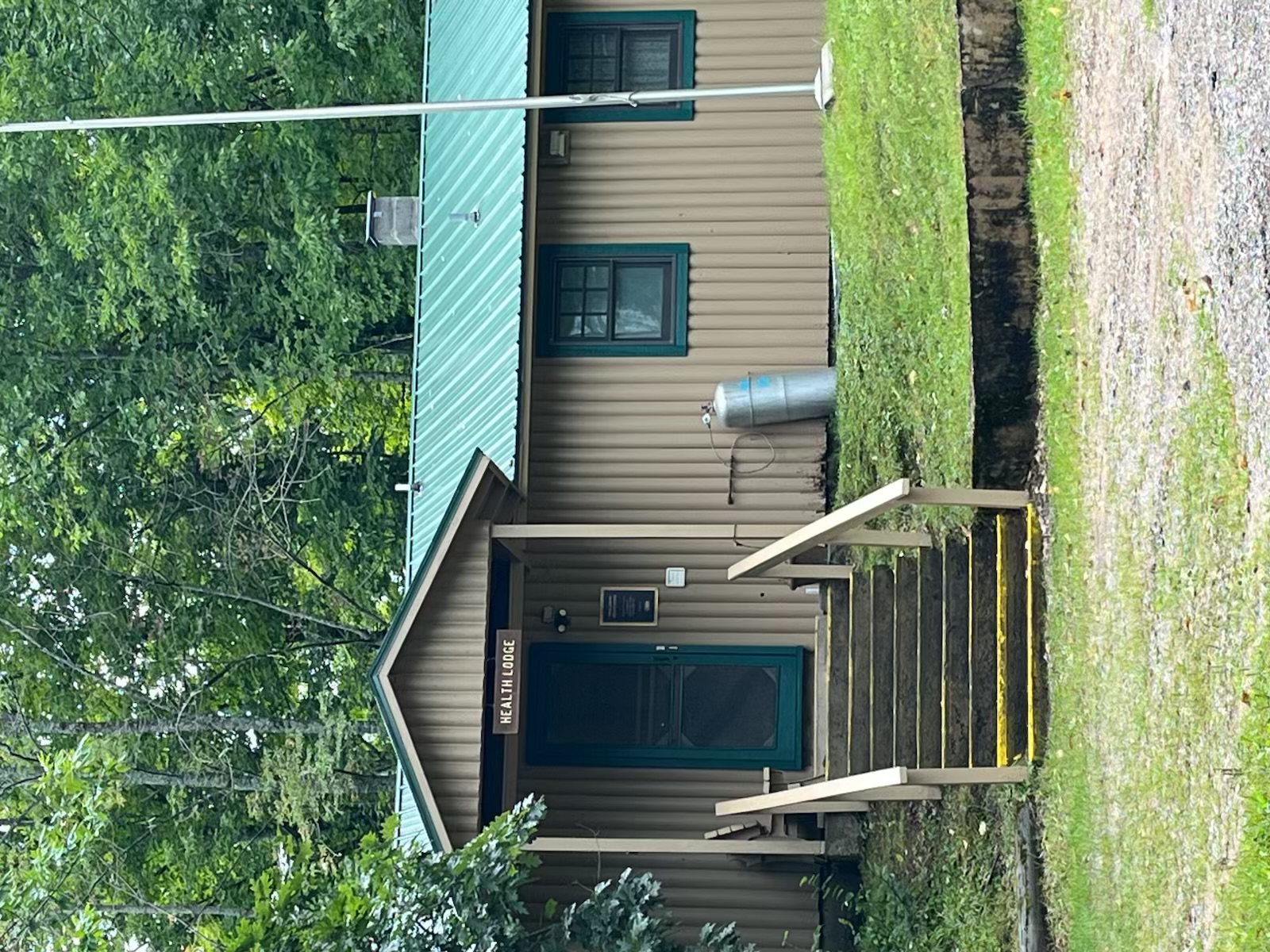 Stone stairs lead up to the Health Lodge entrance.